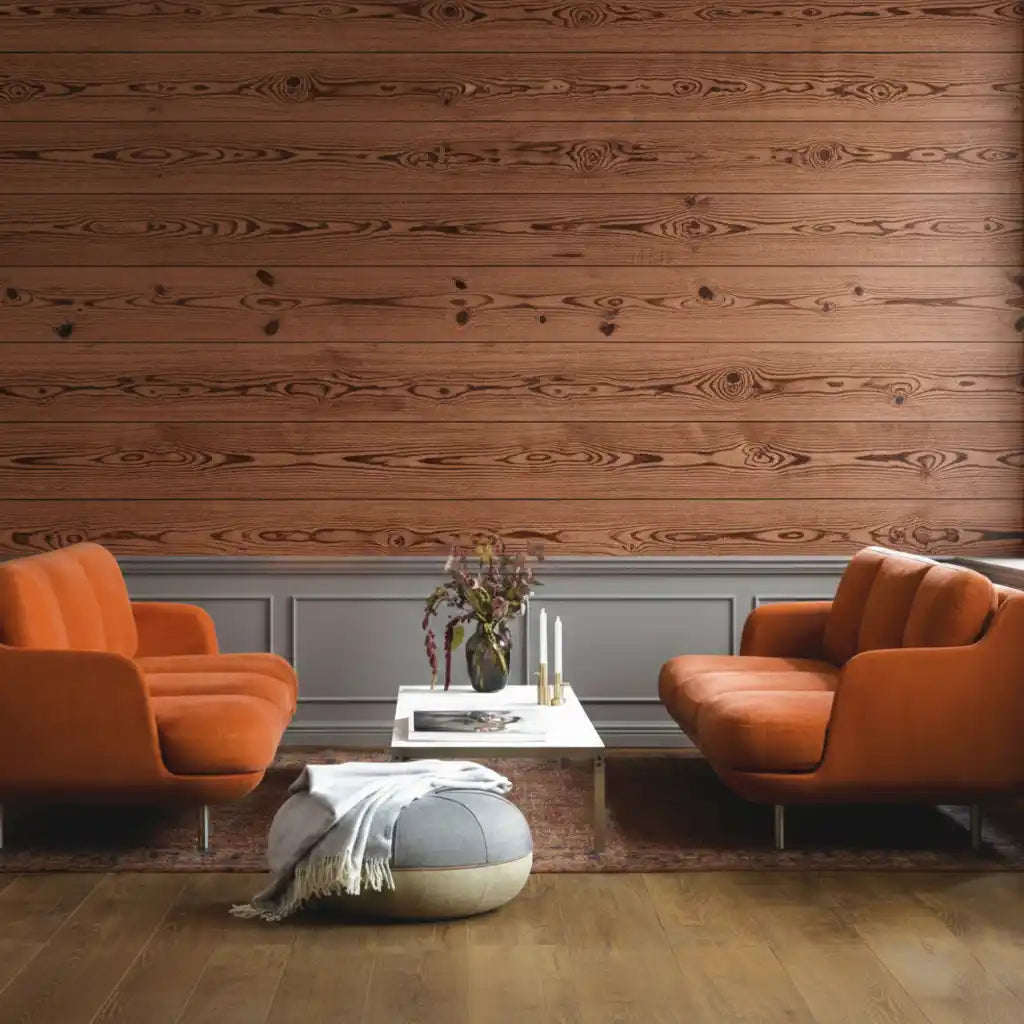 Two orange armchairs in a living room with wooden walls and a coffee table.