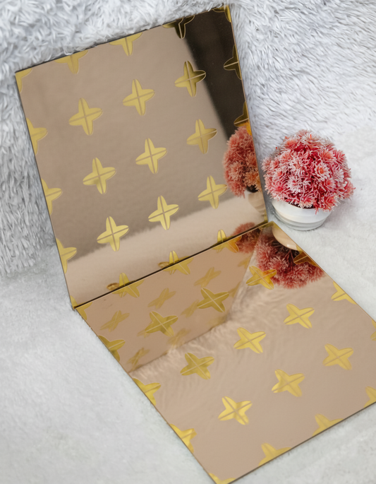 Beige paper with gold star pattern on a white surface with decorative items.