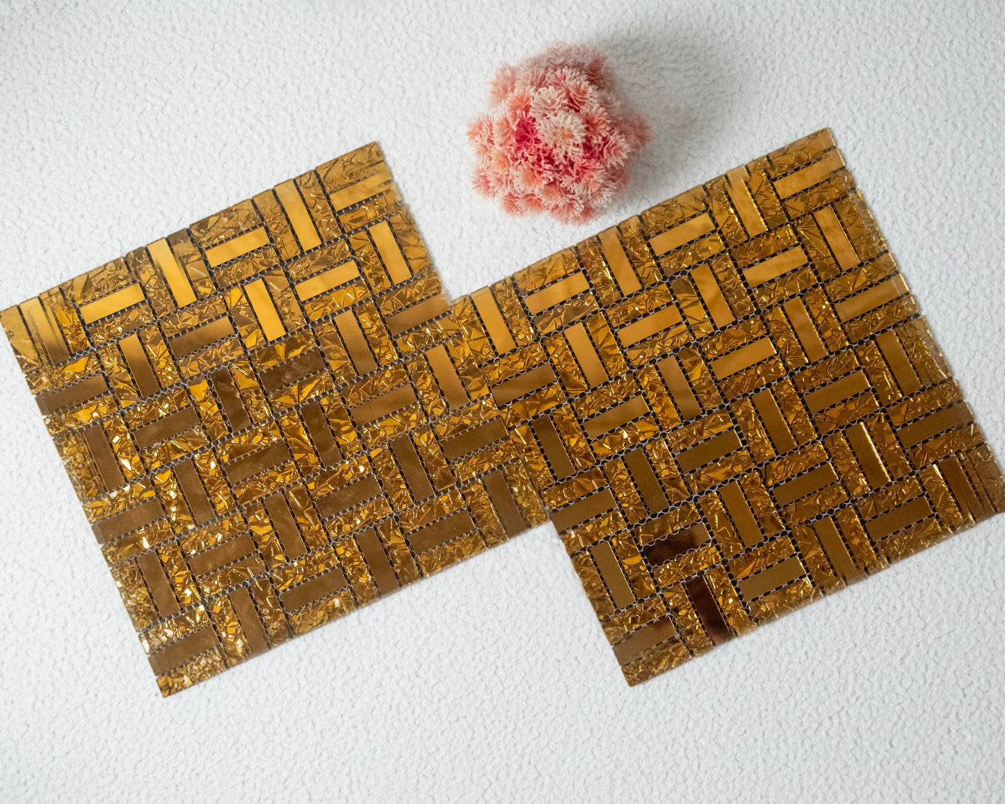 Two woven placemats with a textured flower on a white background