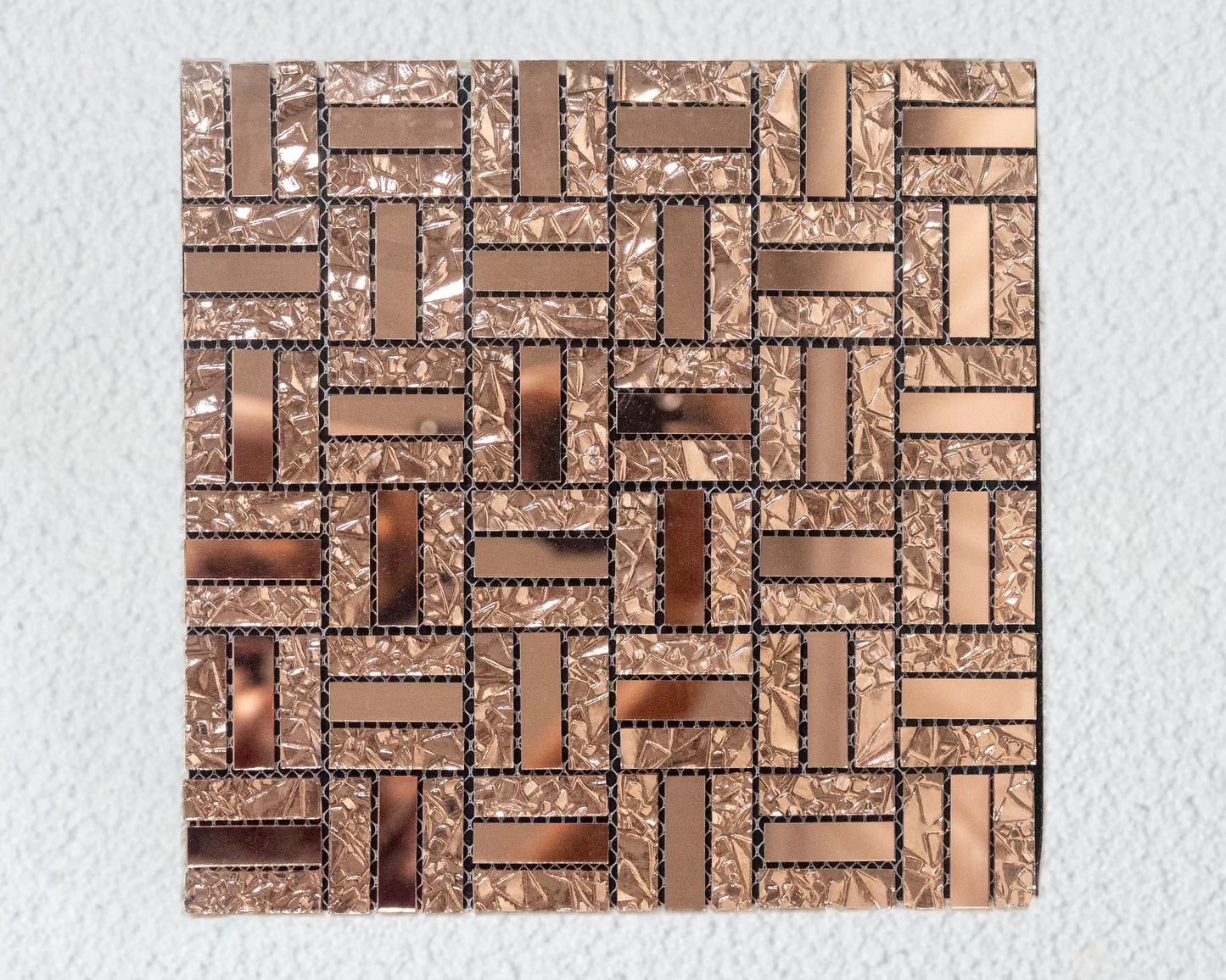 Mosaic pattern of interlocking rectangular tiles on a textured surface