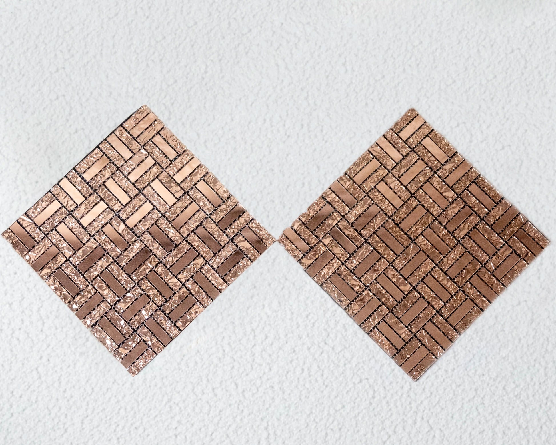 Two woven wooden coasters on a textured white surface