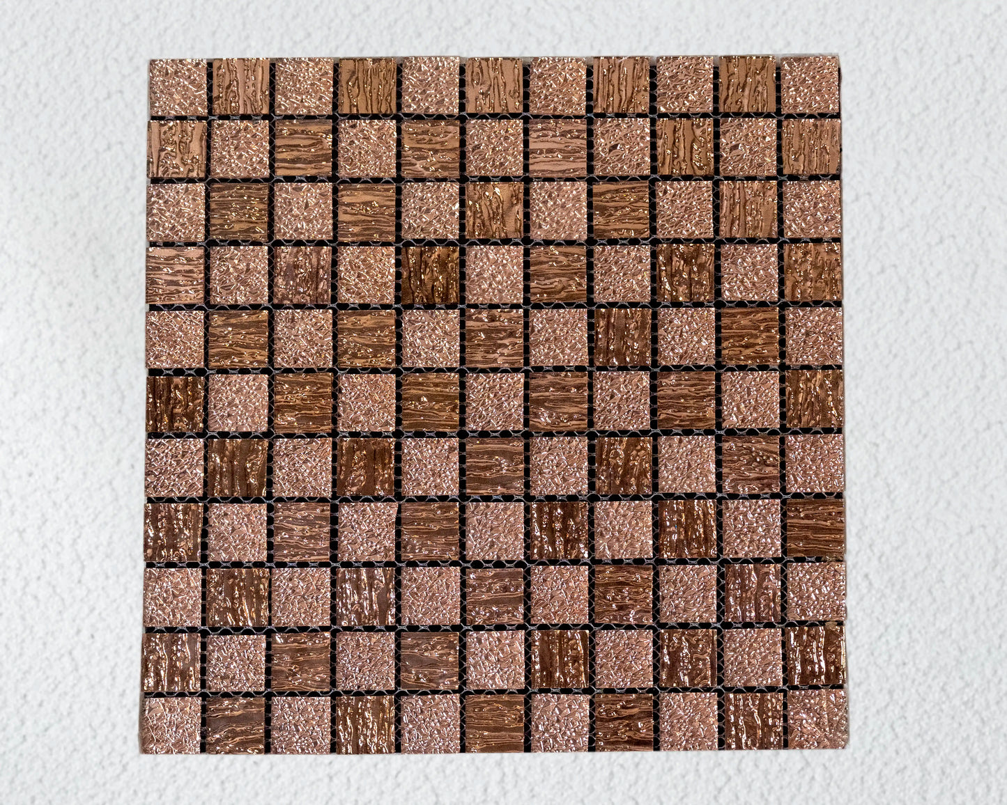 Square tile with a mosaic pattern of brown and beige squares on a white background