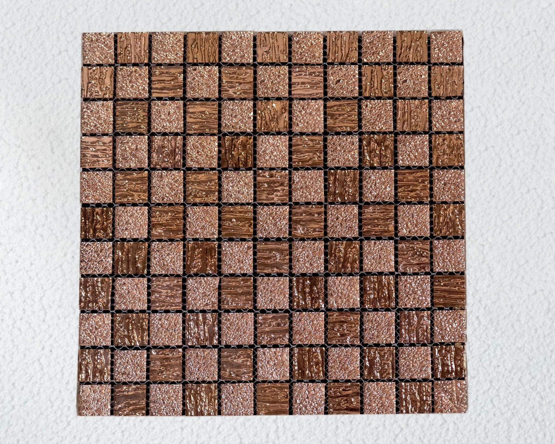 Square tile with a mosaic pattern of brown and beige squares on a white background