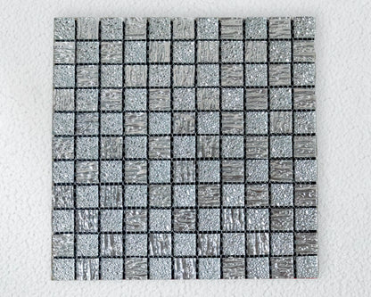 Square mosaic tile with a grid pattern on a light gray background