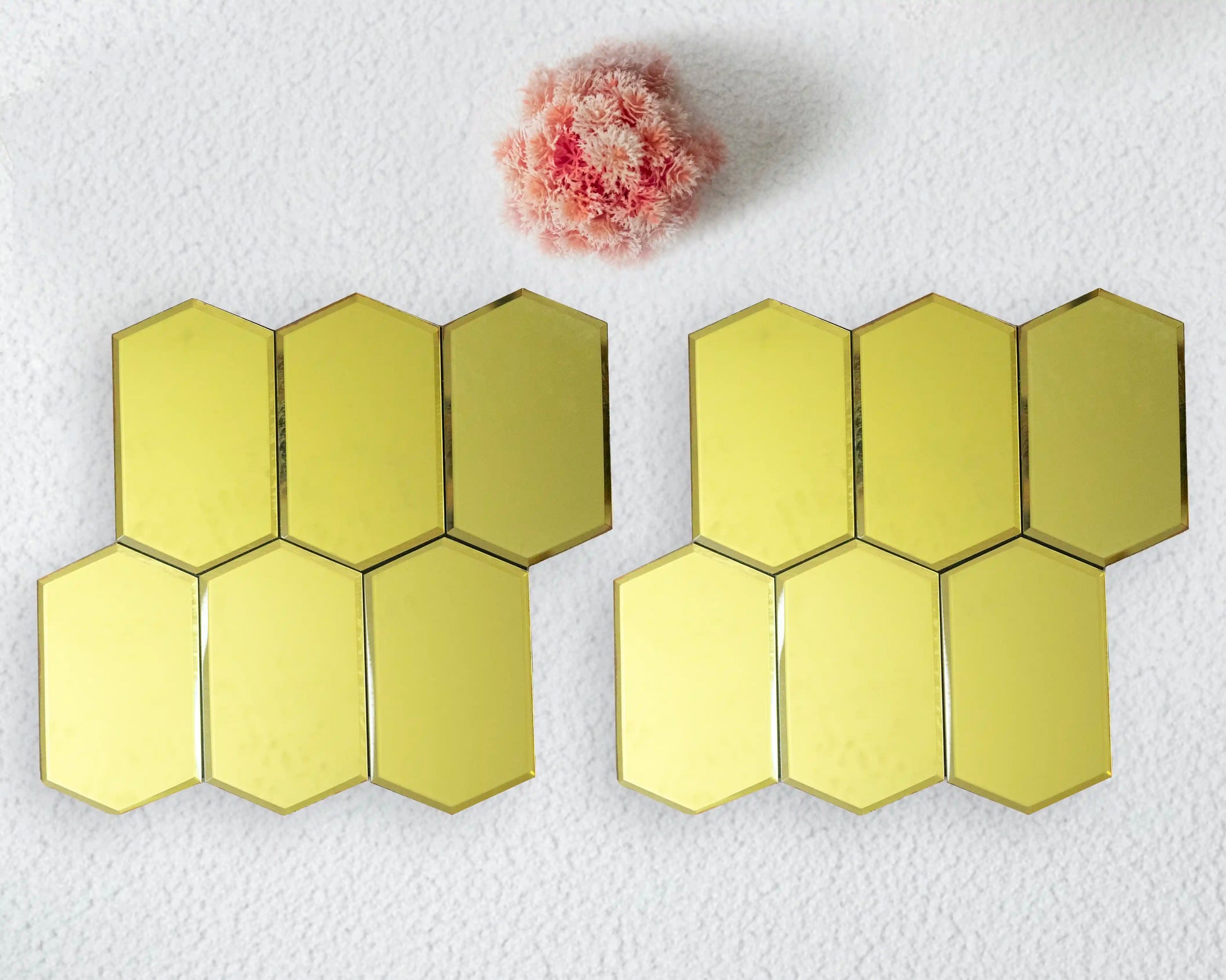 Hexagonal mirror tiles on a white background with a small pink flower.