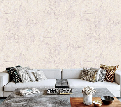 Modern living room with a gray sofa and decorative pillows against a textured light-colored wall.