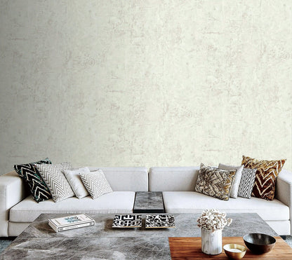 Modern living room with a gray sofa and decorative items against a textured wall.