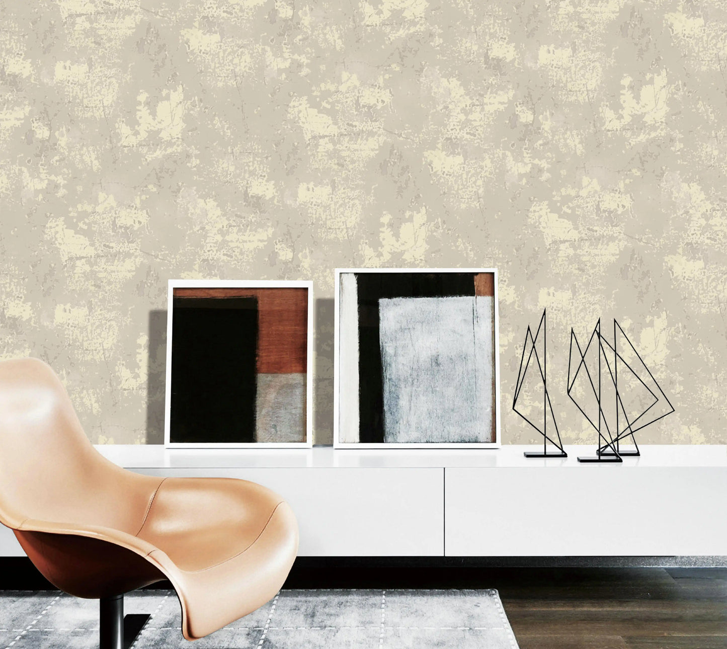Modern interior with abstract art and a chair against a textured wall.