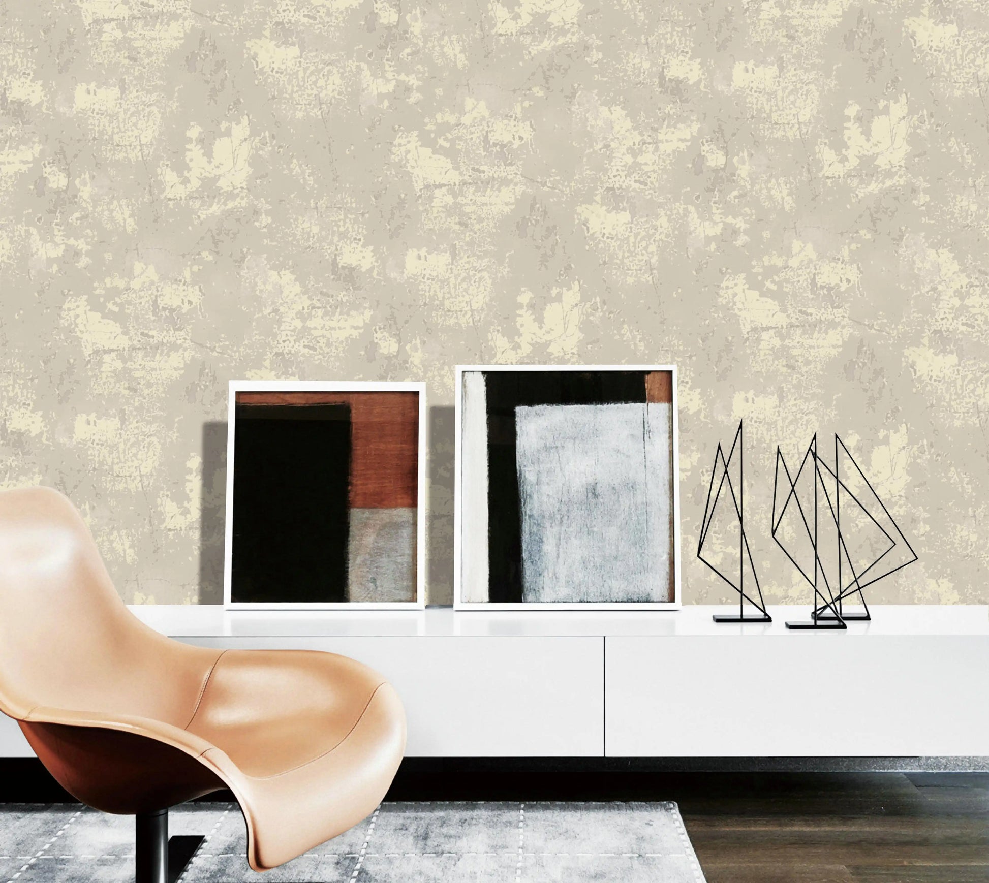Modern interior with abstract art and a chair against a textured wall.