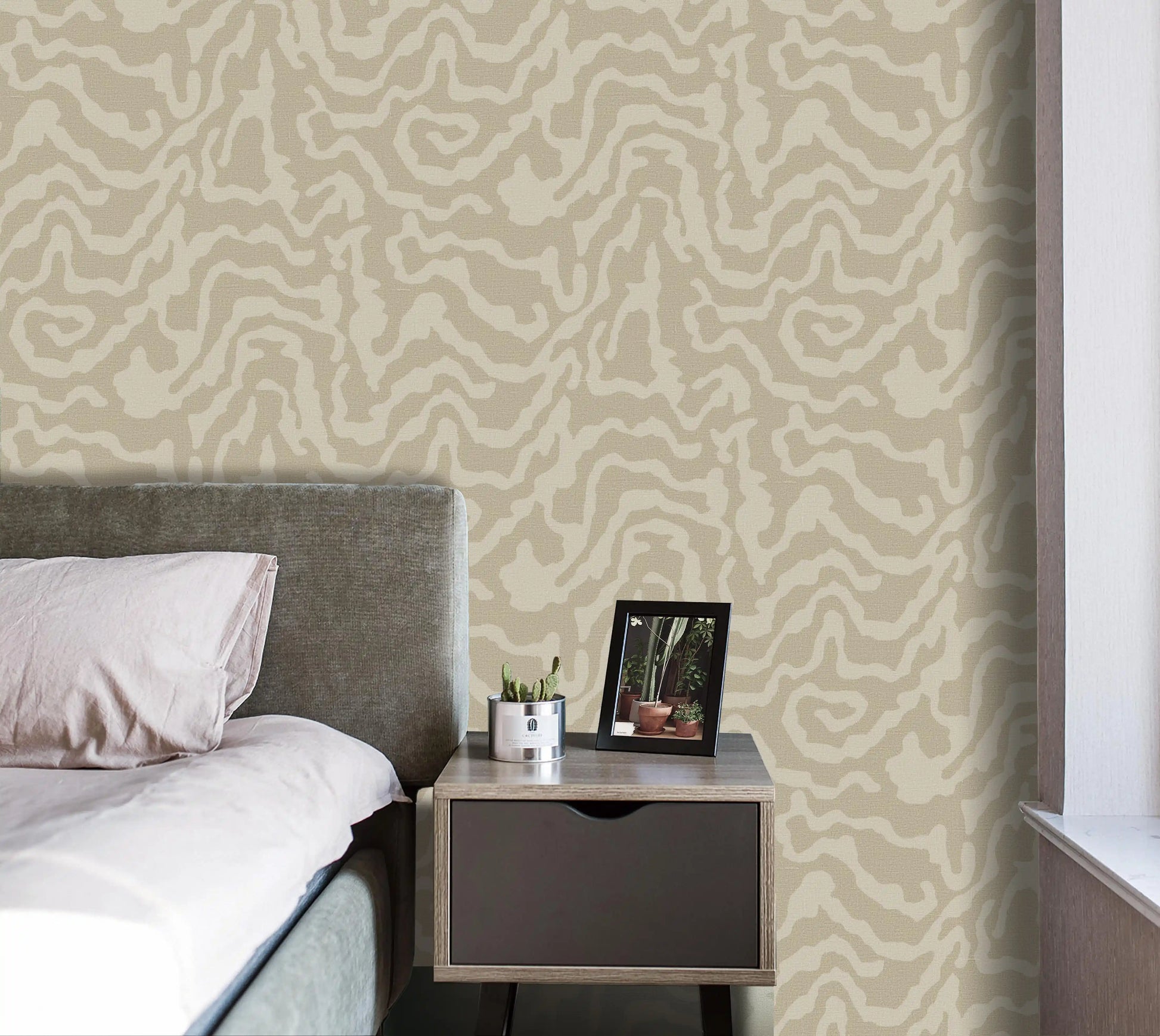 Bedroom with patterned wallpaper, bed, and nightstand.