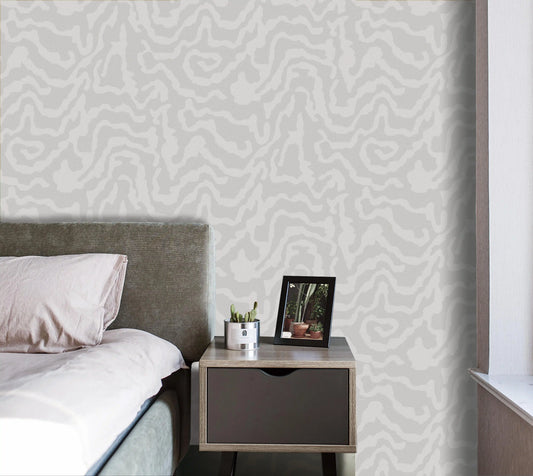 Bedroom with a bed and nightstand against a patterned wall.