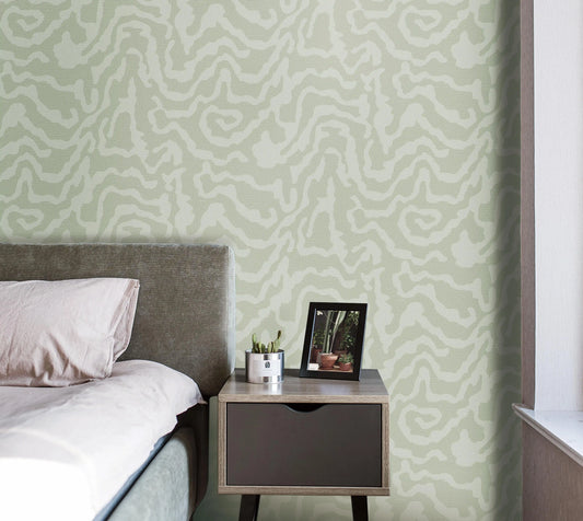 Bedroom with patterned wallpaper, bed, and nightstand.