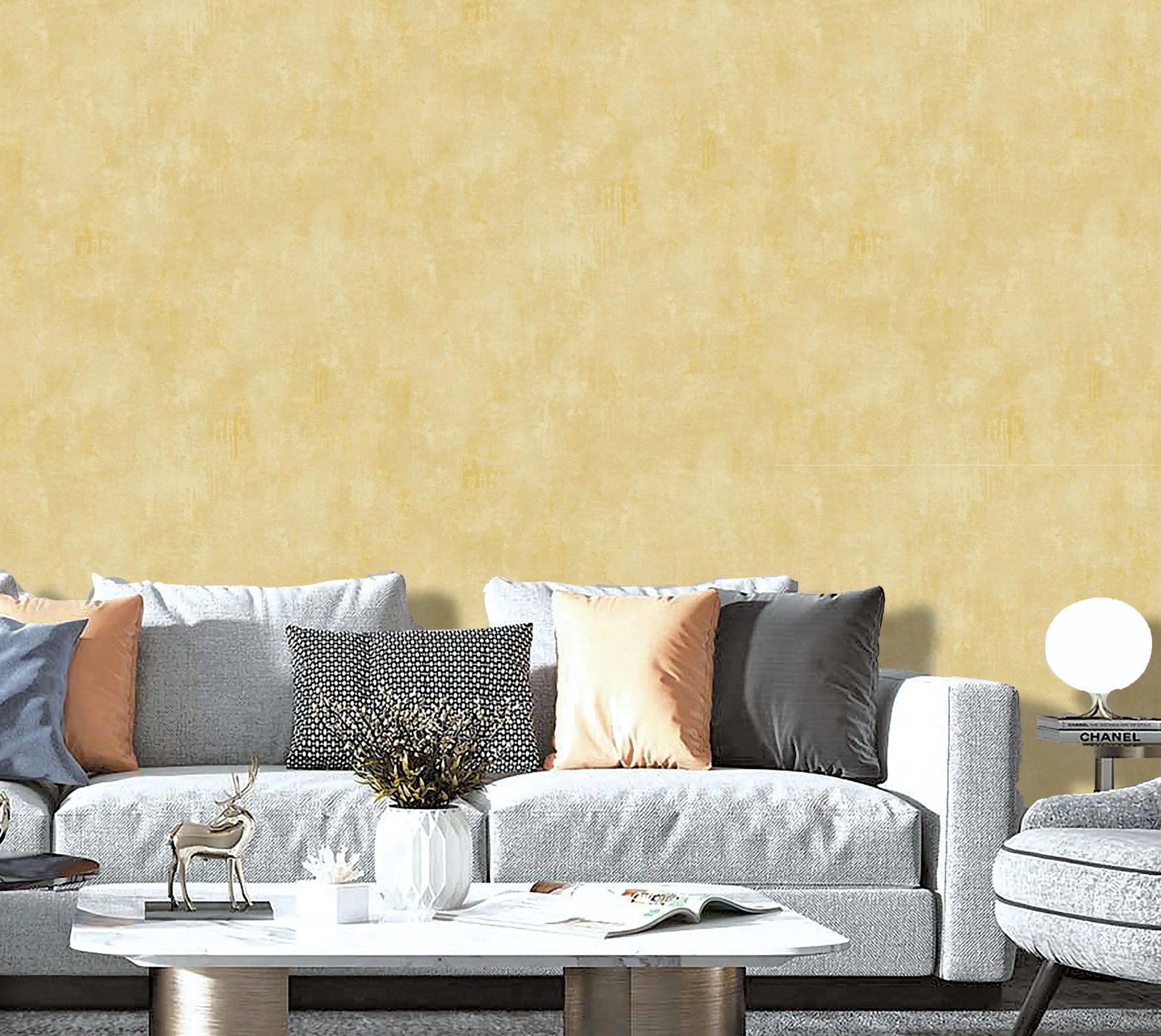 Gray sofa with decorative pillows against a yellow wall
