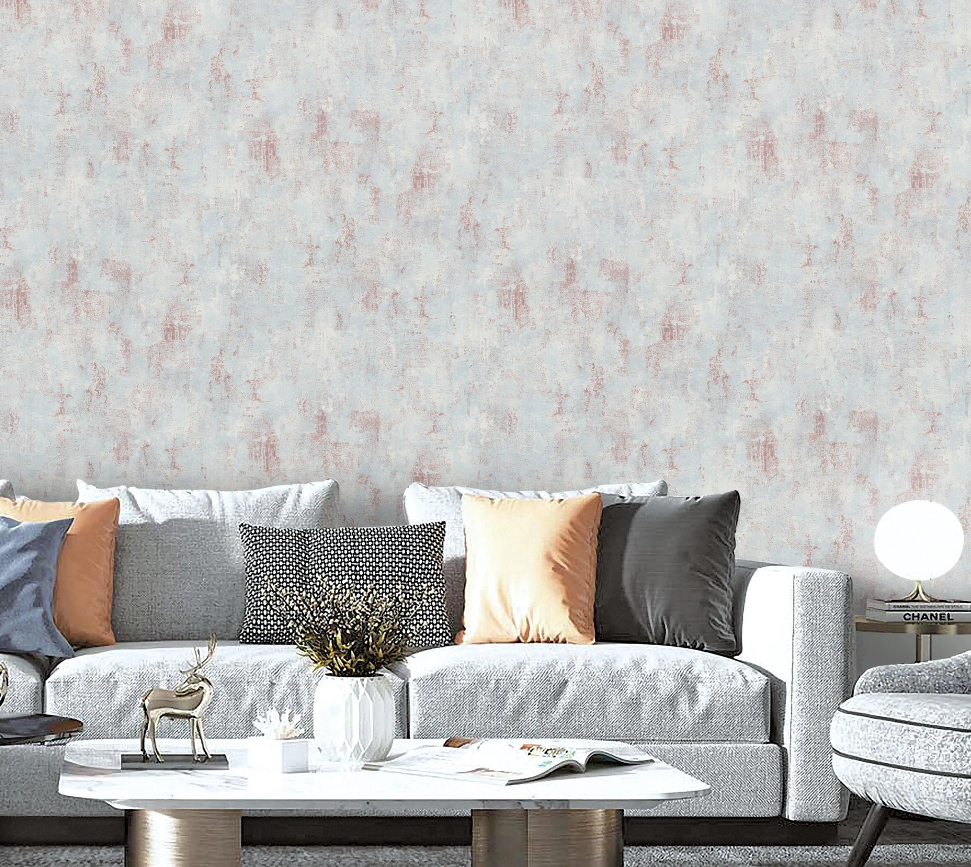 Living room with a gray sofa, decorative pillows, and a textured wall.