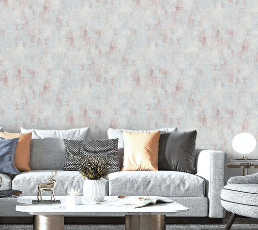 Living room with a gray sofa, decorative pillows, and a textured wall.