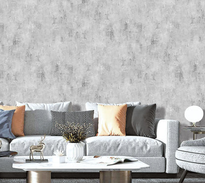 Gray textured wallpaper with a gray sofa and decorative items in a living room setting.