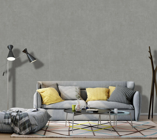 Modern living room with a gray sofa, yellow cushions, and decorative items.