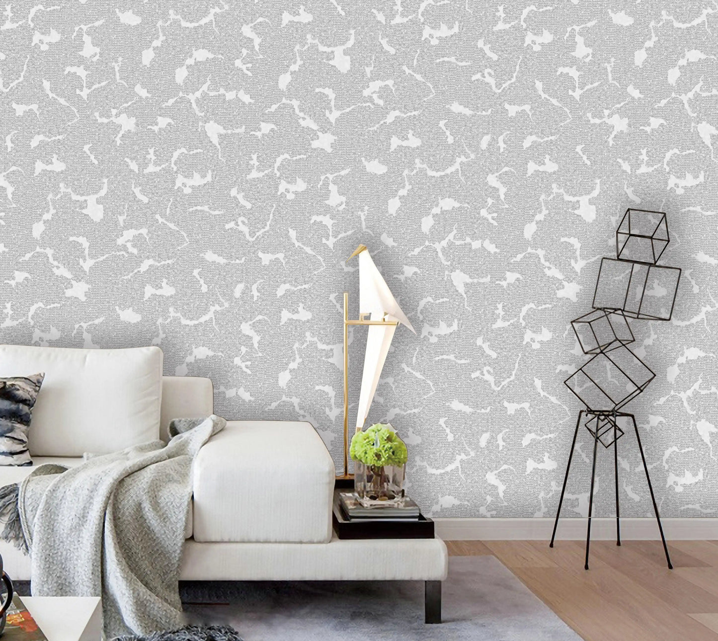 Living room with gray and white patterned wallpaper, white sofa, and decorative elements.