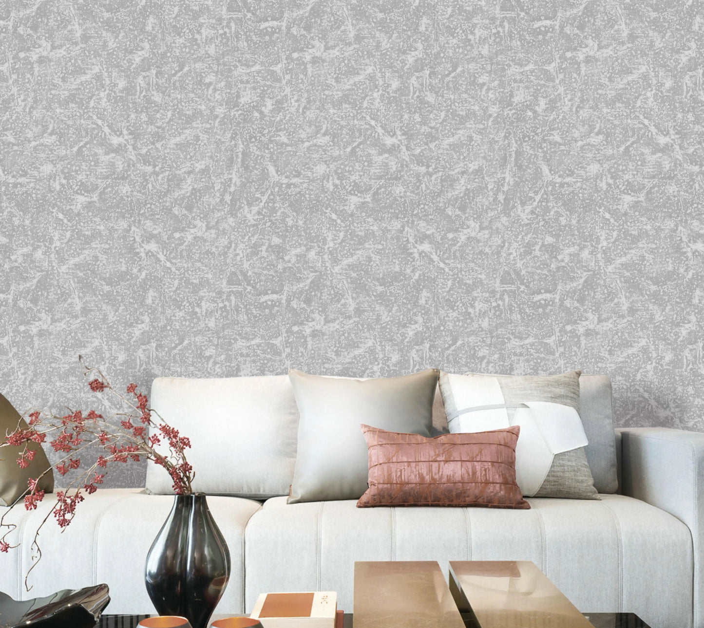 Living room with a gray textured wall, white sofa, and decorative elements.