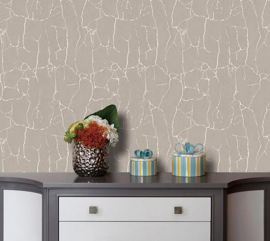 Wallpaper with a marble-like pattern on a wall behind a dresser with decorative items.
