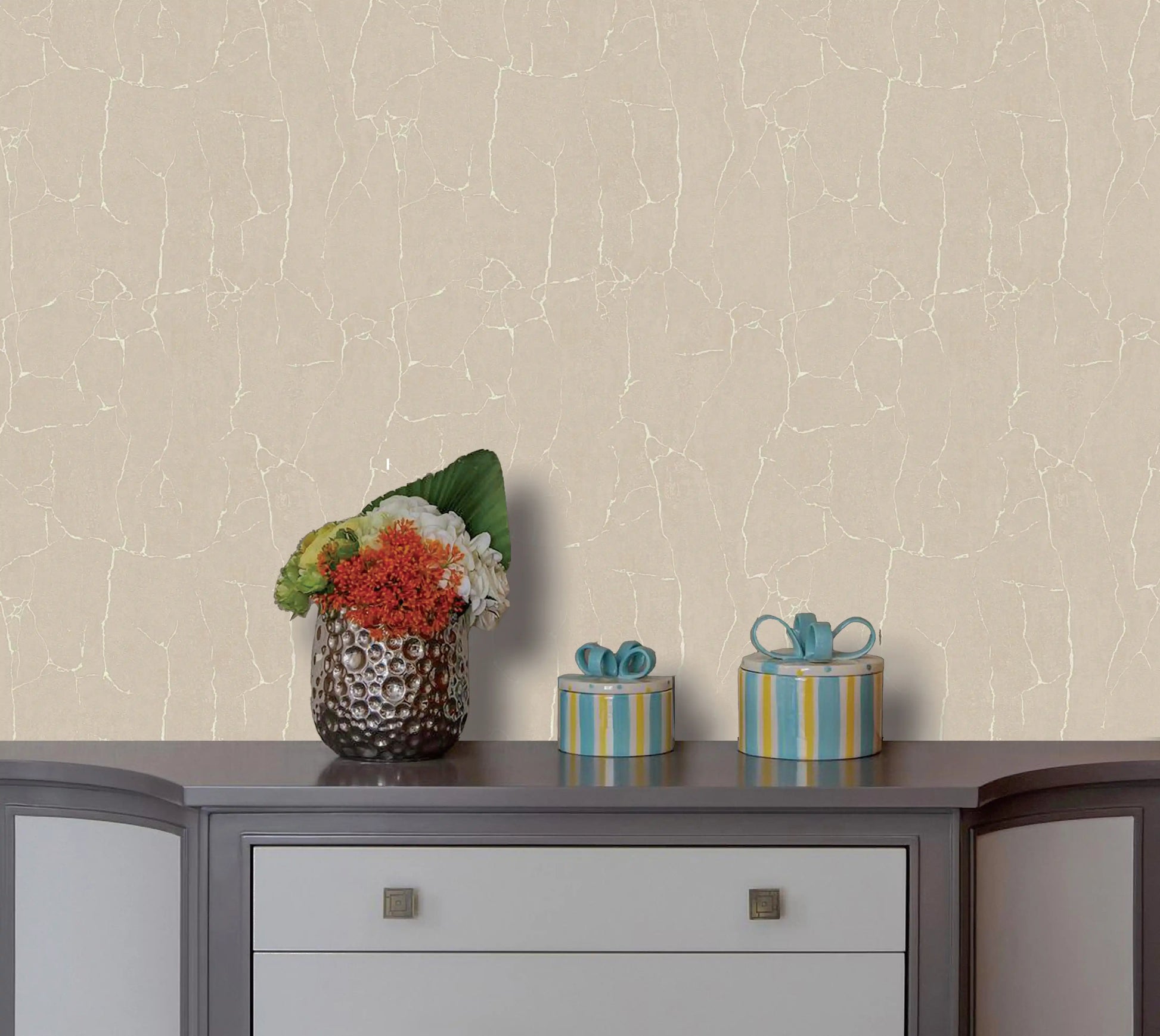Decorative items on a table against a textured beige wall
