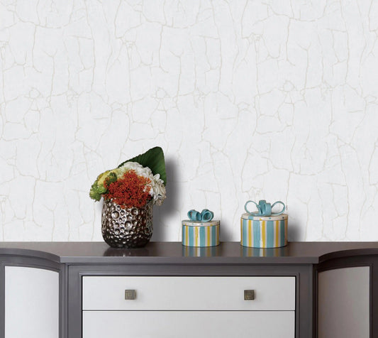 Decorative items on a wooden surface with a textured white wall background