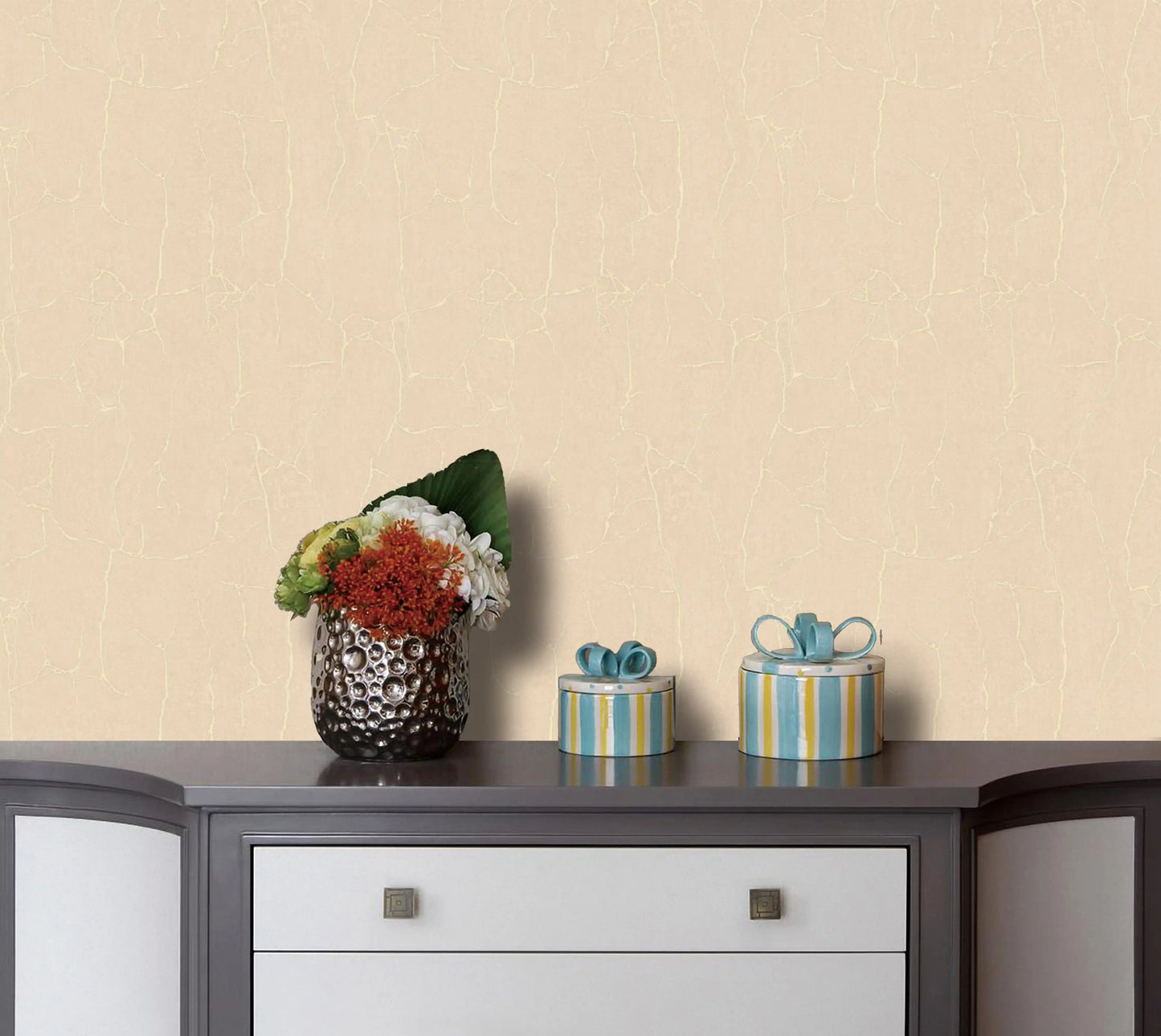 Decorative items on a table against a beige wall