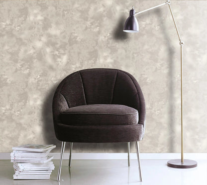 Modern armchair with a floor lamp against a textured wall.