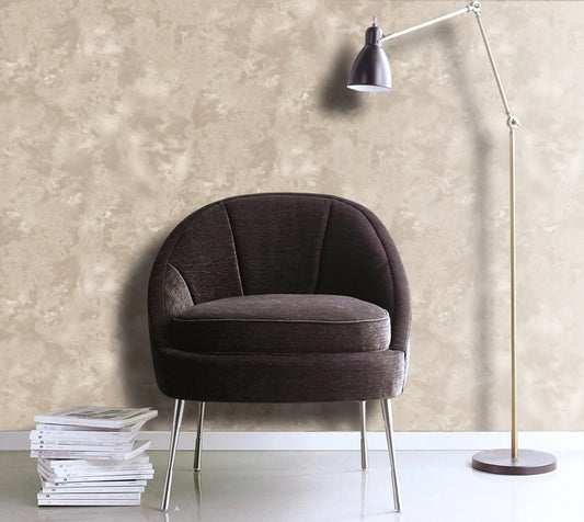 Brown armchair with a lamp and books against a beige wall