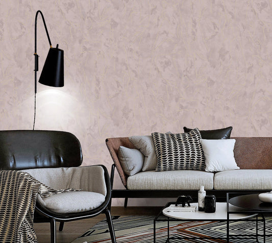 Modern living room with a sofa, chair, and decorative pillows against a textured wall.